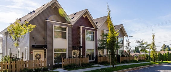 Multi-family homes showcasing various siding styles and colors, highlighting architectural diversity and design aesthetics